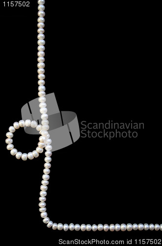 Image of White pearls on the black silk 