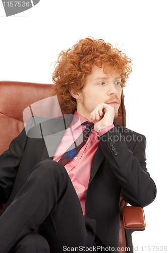 Image of young businessman sitting in chair