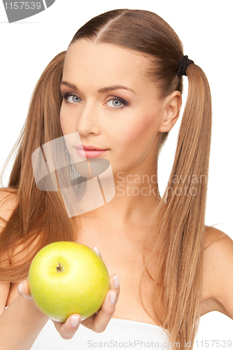 Image of young beautiful woman with green apple