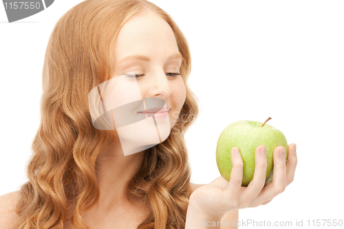 Image of young beautiful woman with green apple