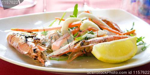 Image of Italy.Royal shrimps fried on a grill with vegetables 