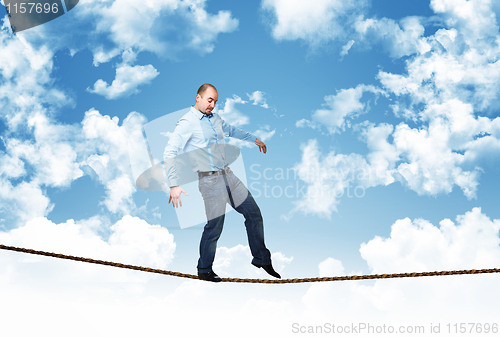 Image of man walk on rope