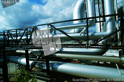 Image of Industrial zone, Steel pipelines and valves against blue sky