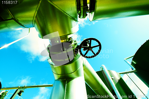 Image of Industrial zone, Steel pipelines and valves against blue sky