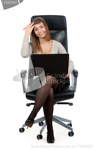 Image of Young business lady in a chair with a laptop