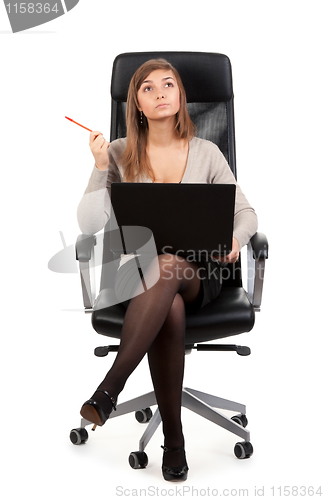 Image of Young business lady in a chair with a laptop