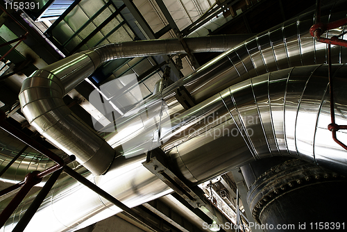 Image of different size and shaped pipes and valves at a power plant 