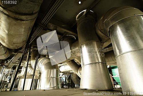 Image of different size and shaped pipes and valves at a power plant 