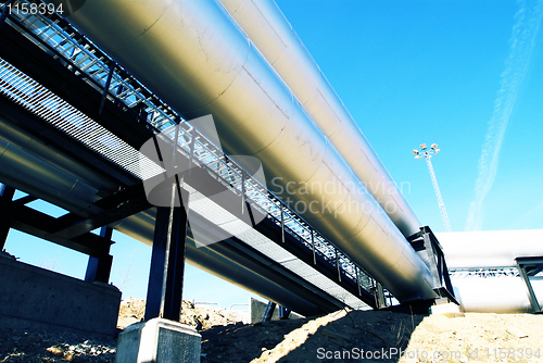 Image of Industrial zone, Steel pipelines and valves against blue sky