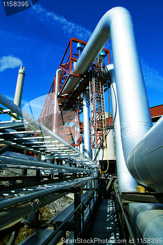 Image of Industrial zone, Steel pipelines and valves against blue sky