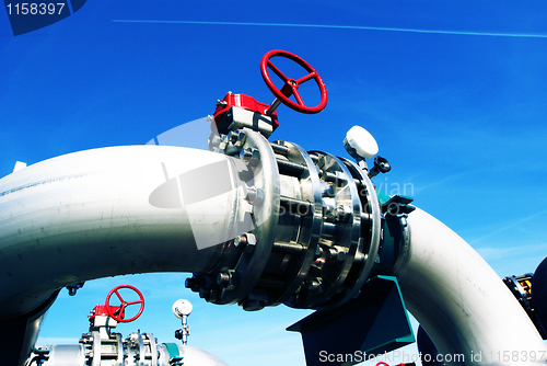 Image of Industrial zone, Steel pipelines and valves against blue sky