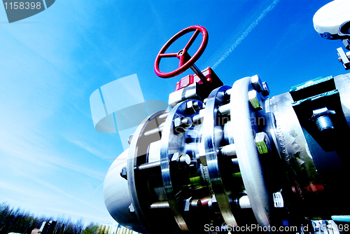 Image of Industrial zone, Steel pipelines and valves against blue sky