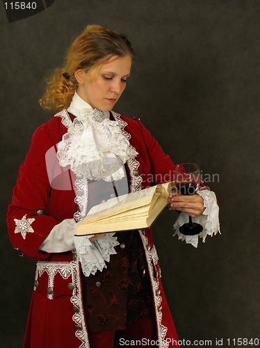 Image of Woman in old-fashioned french clothes reading a book