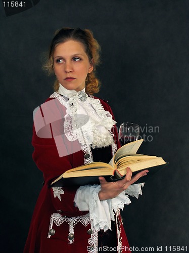 Image of Woman in old-fashioned french clothes with a book