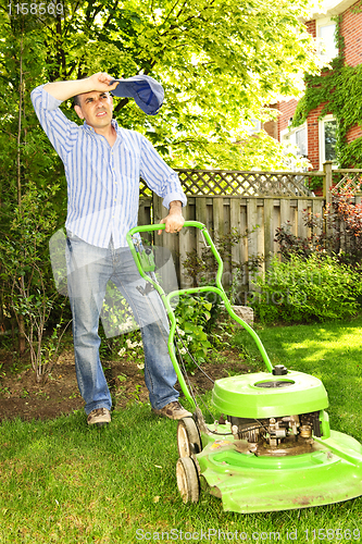 Image of Man mowing lawn