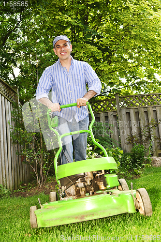 Image of Man mowing lawn