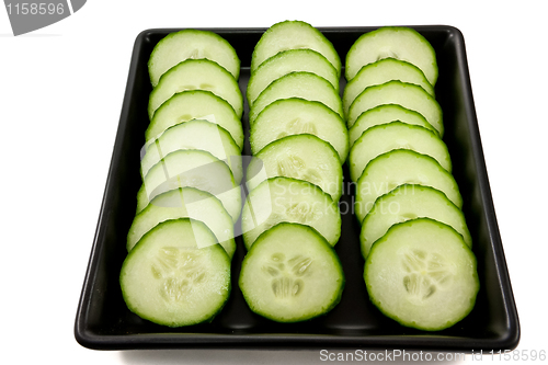 Image of Sliced cucumber on a black plate