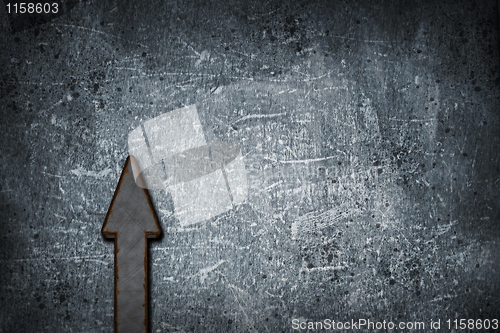 Image of rusty arrow on grunge background