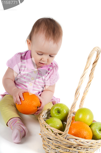 Image of Baby girl in pink and fruits