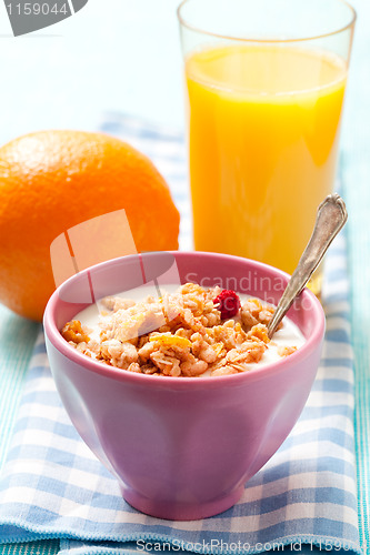 Image of Breakfast with cereal, orange and orange juice