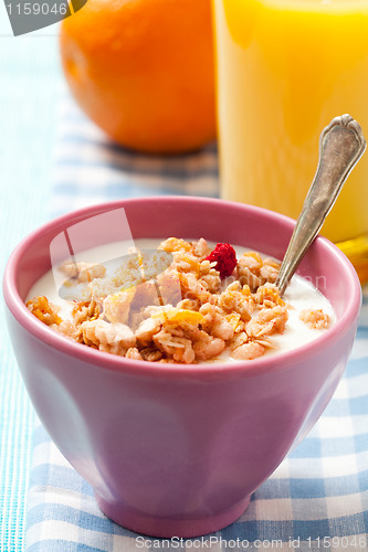Image of Breakfast with cereal, orange and orange juice