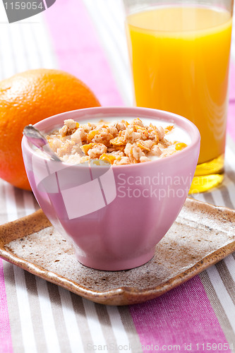 Image of Breakfast with cereal, orange and orange juice