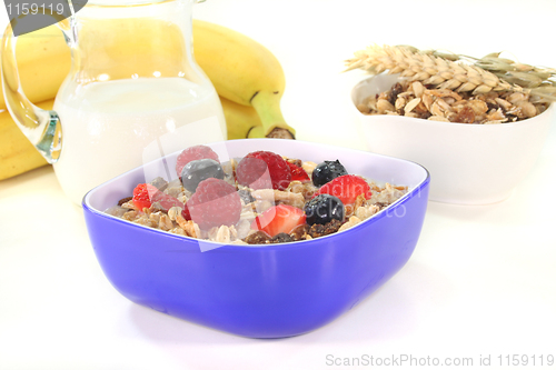 Image of muesli with milk, fresh fruits and nuts