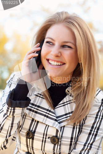 Image of Pretty Young Blond Woman on Phone Outside
