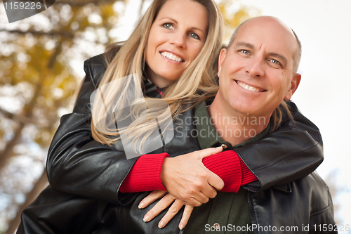 Image of Attractive Couple in Park with Leather Jackets