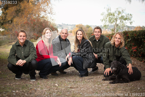 Image of Attractive Family Pose for a Portrait Outdoors