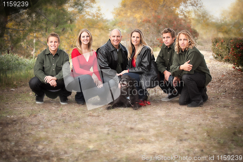 Image of Attractive Family Pose for a Portrait Outdoors