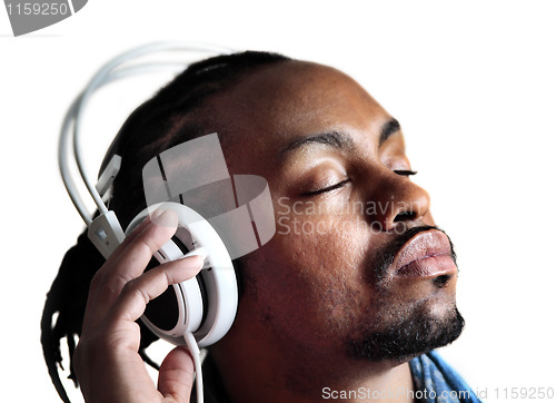 Image of Male listening to headphones with eyes closed