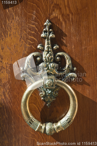 Image of coppery wrought door knocker