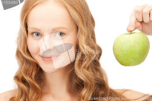 Image of young beautiful woman with green apple