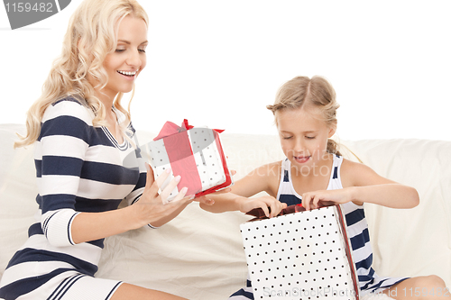 Image of mother and little girl with gifts