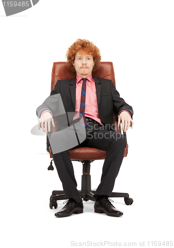 Image of young businessman sitting in chair