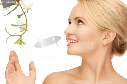 Image of beautiful woman with orchid flower