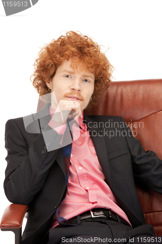 Image of young businessman sitting in chair