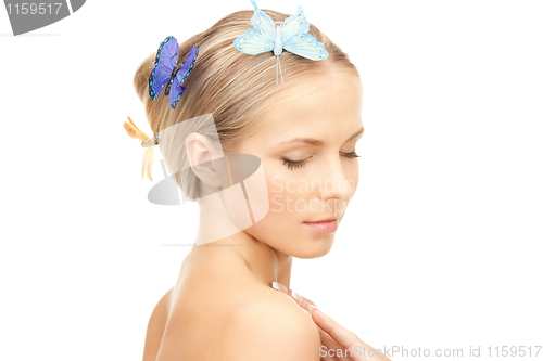 Image of beautiful woman with butterfly in hair