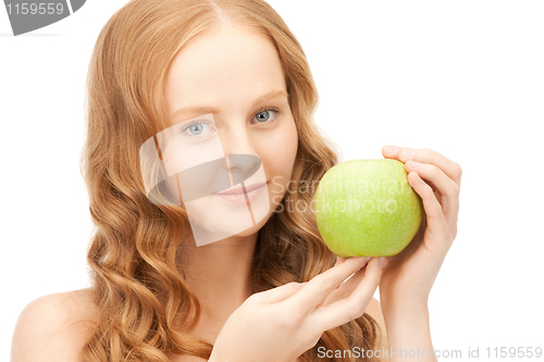 Image of young beautiful woman with green apple