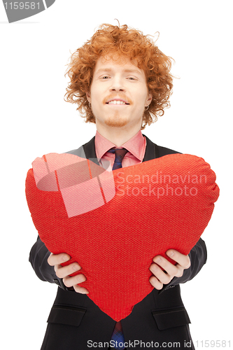 Image of handsome man with red heart-shaped pillow