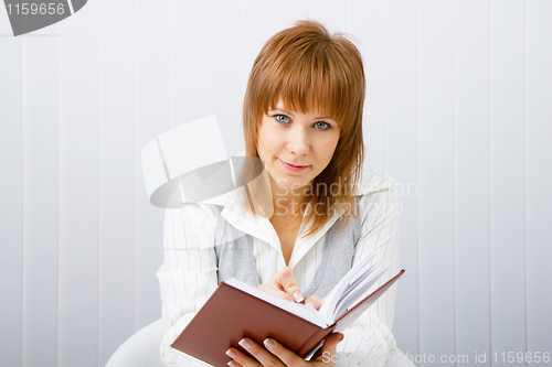Image of business woman with book