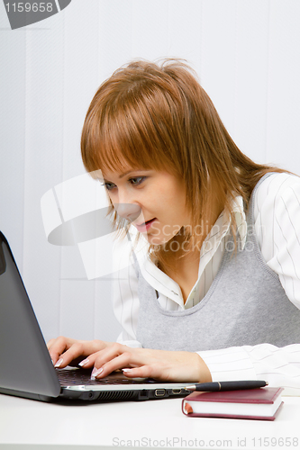 Image of girl watching with interest to monitor