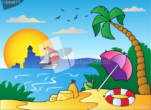 Image of Beach with umbrella and sand castle