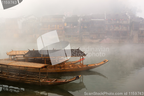 Image of China river landscape with boats and traditional architecture
