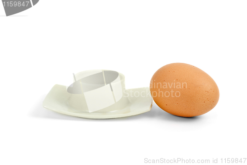 Image of Brown boiled egg near eggcup