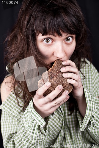 Image of beggar woman eating bread