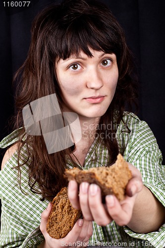 Image of beggar woman with a piece of bread in her hands