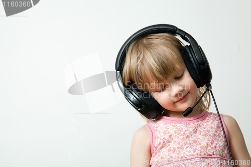 Image of Little girl with headphones
