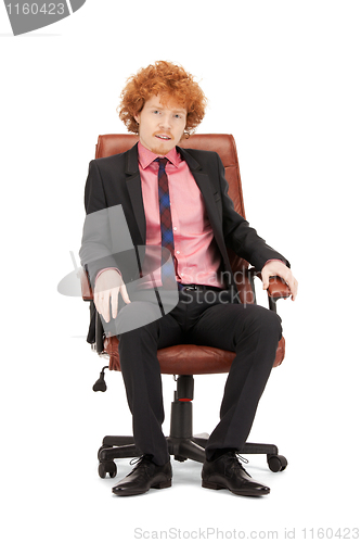 Image of young businessman sitting in chair